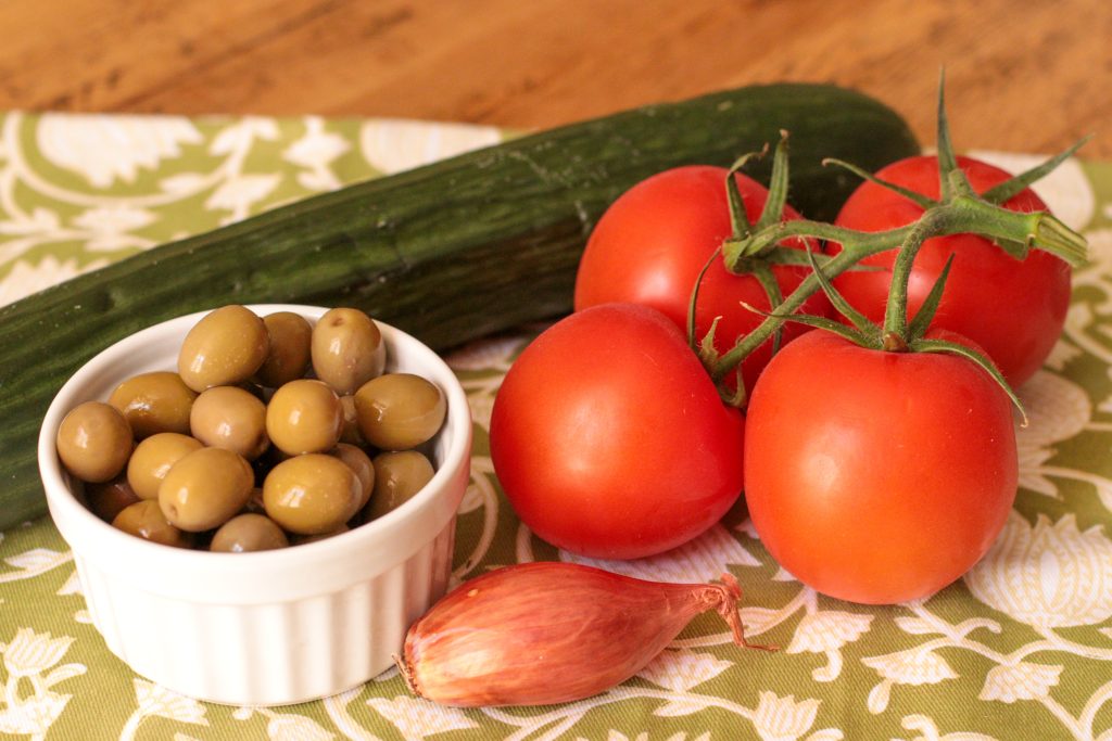 vegetable ingredients for greek salad with quinoa: cucumber, olives, tomatoes and shallot