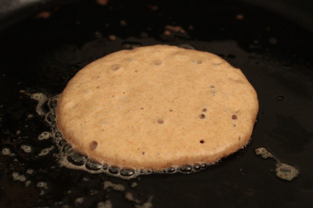 sourdough pancake cooking on a skillet