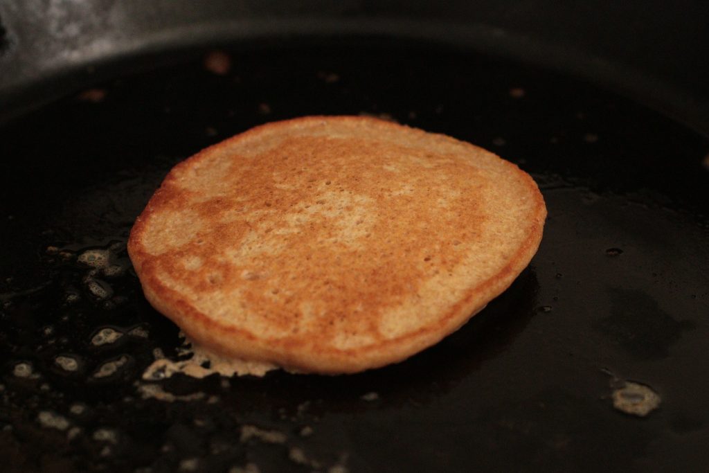 flipped sourdough pancake on skillet