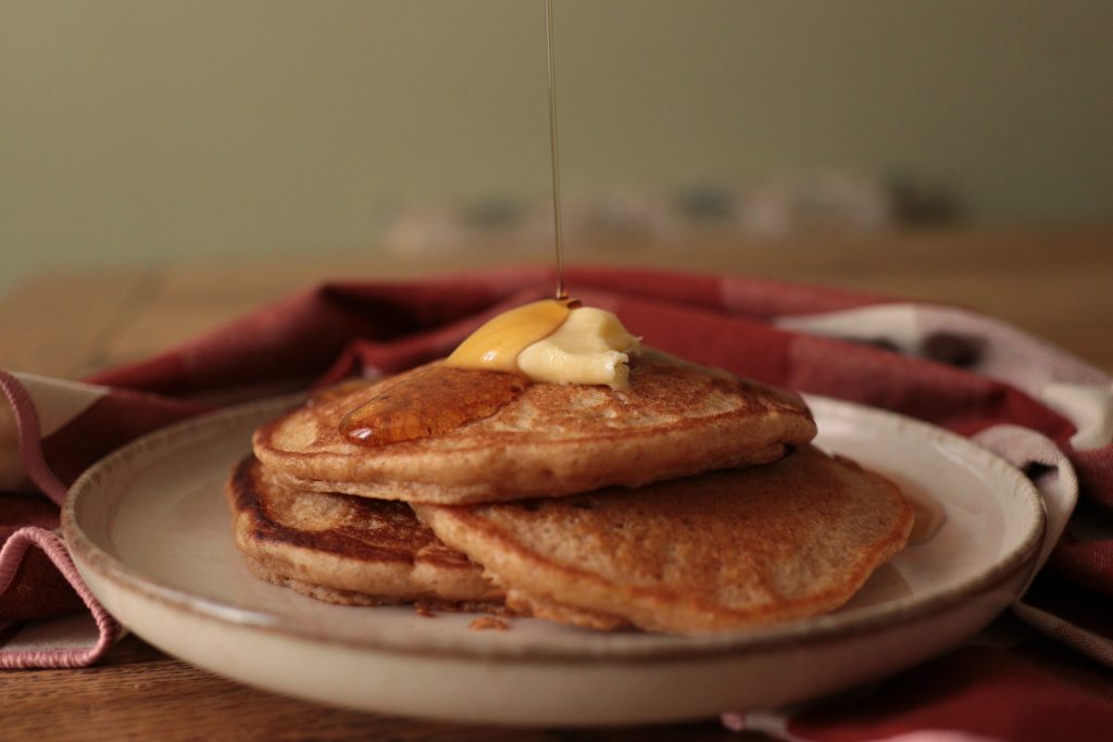 einkorn sourdough pancakes with butter and maple syrup drizzle