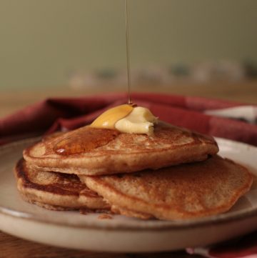 einkorn sourdough pancakes with butter and maple syrup drizzle