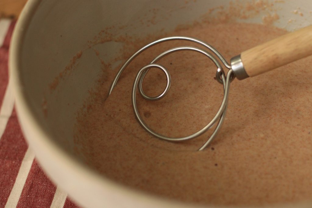 pancake batter in a bowl with a danish dough hook