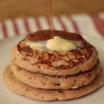 Sourdough Discard Pancakes with Fresh Milled Flour with butter and maple syrup being drizzled