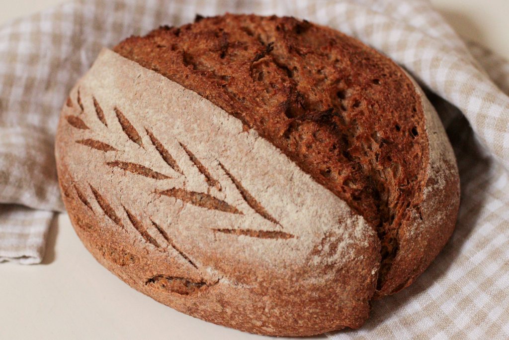 whole grain artisan loaf and checked tea towel
