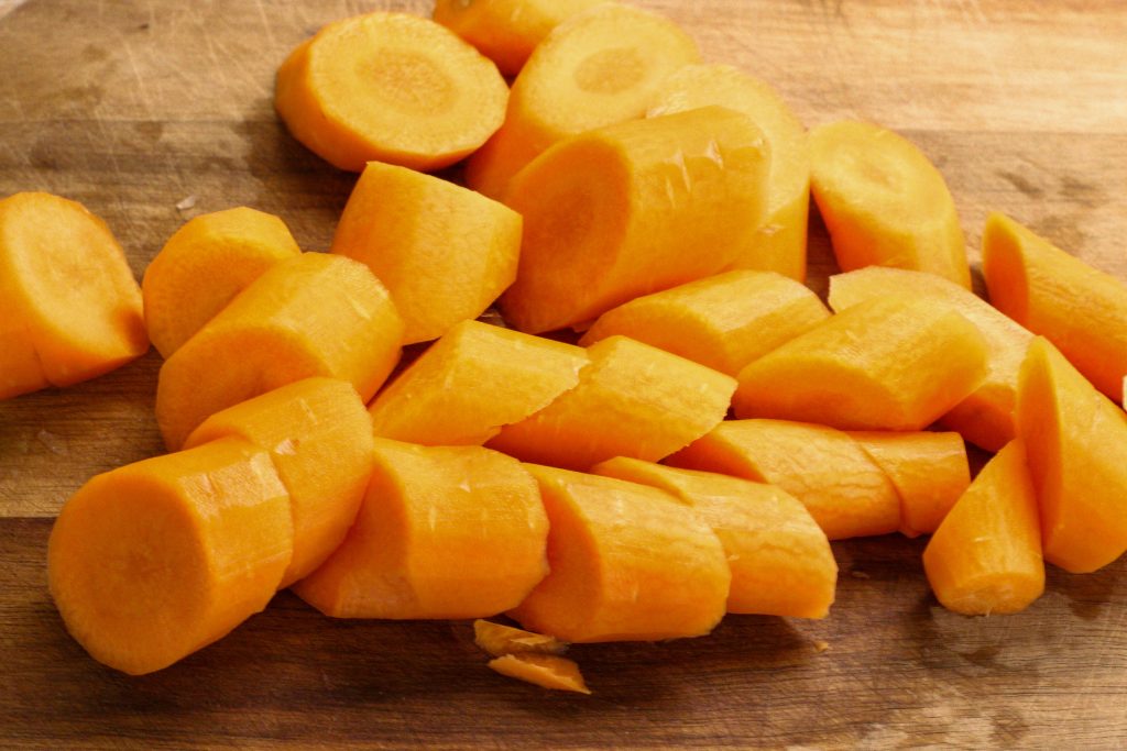 carottes, coupées en morceaux de 1 pouce sur une planche à découper