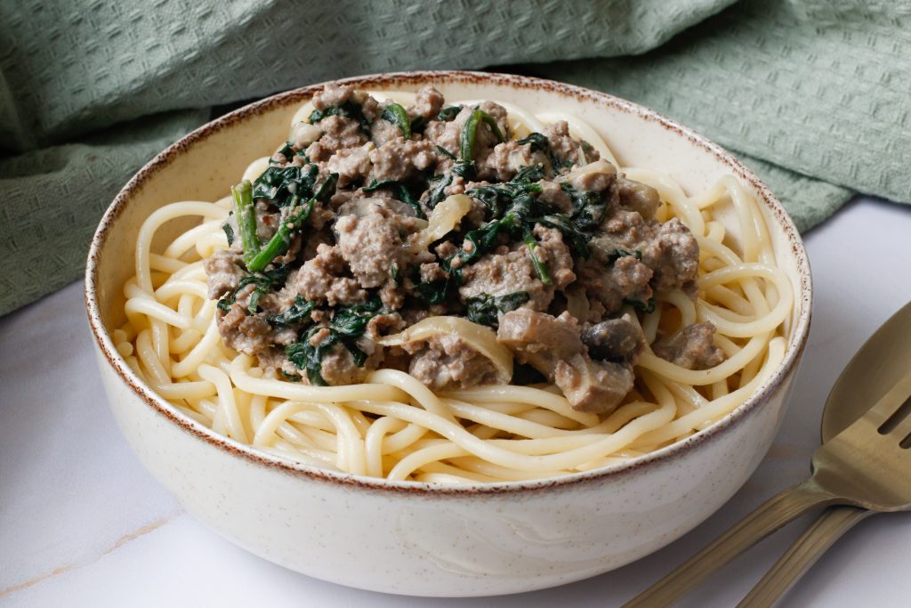 Easy ground beef stroganoff in cream bowl served with pasta