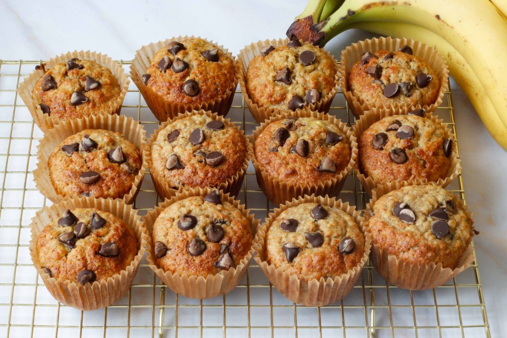 Sourdough banana oat muffins with chocolate chips on a wire rack